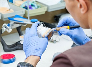 Dental lab technician working on dentures