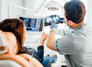 Dentist and patient discussing X-ray